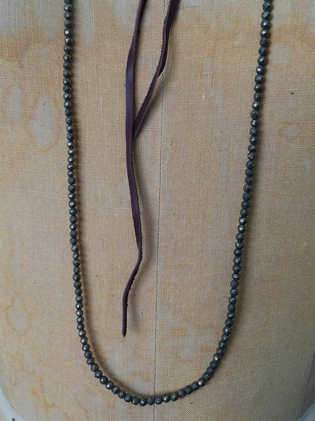 Alicia Van Fleteren necklace has dark pyrite attached to brown leather ties.