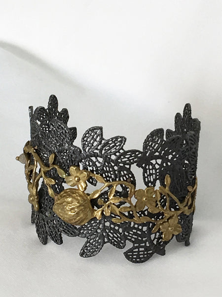 Bracelet by Lotta, leaf pattern in antiques bronze with floral motifs in 14K gold and labradorite accent