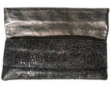 Flap up on Lousie Farnay black laser cut leather clutch, bronze backing
