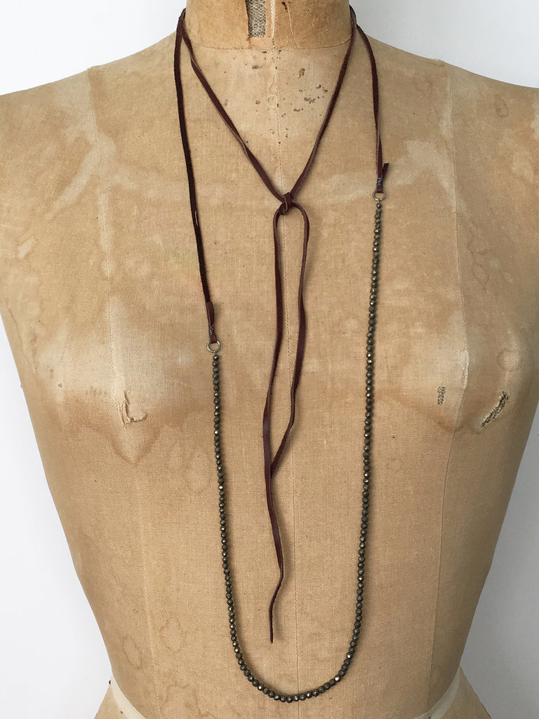 Alicia Van Fleteren necklace has dark pyrite attached to brown leather ties.