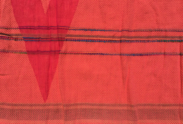 Detail of the Letol scarf, Desiree scarf in warm oranges and reds with hints of blue and green.