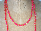 Close up of Lil Jewellry, faceted crystal necklace in hot pink