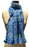 The Letol Twilight scarf has organic and novel motifs in white, with a spectrum of turquoise and blues.