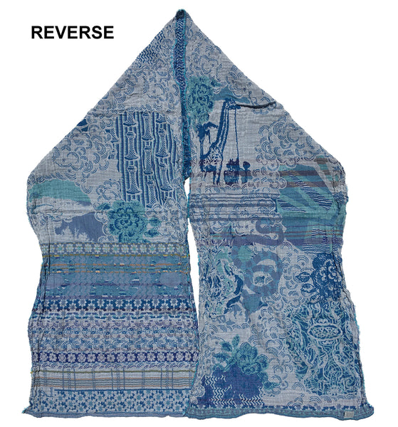 Reverse of Letol Twilight scarf in white, with a spectrum of turquoise and blues.